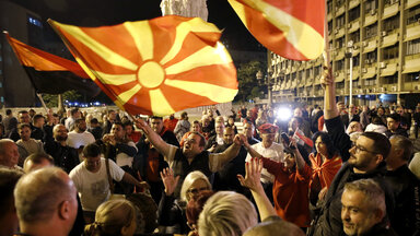 Supporters of the opposition center-right VMRO-DPMNE party celebrate in front of the party headquarters after their party announced victory in the presidential and parliamentary elections, in Skopje, North Macedonia, late Wednesday, May 8, 2024. (