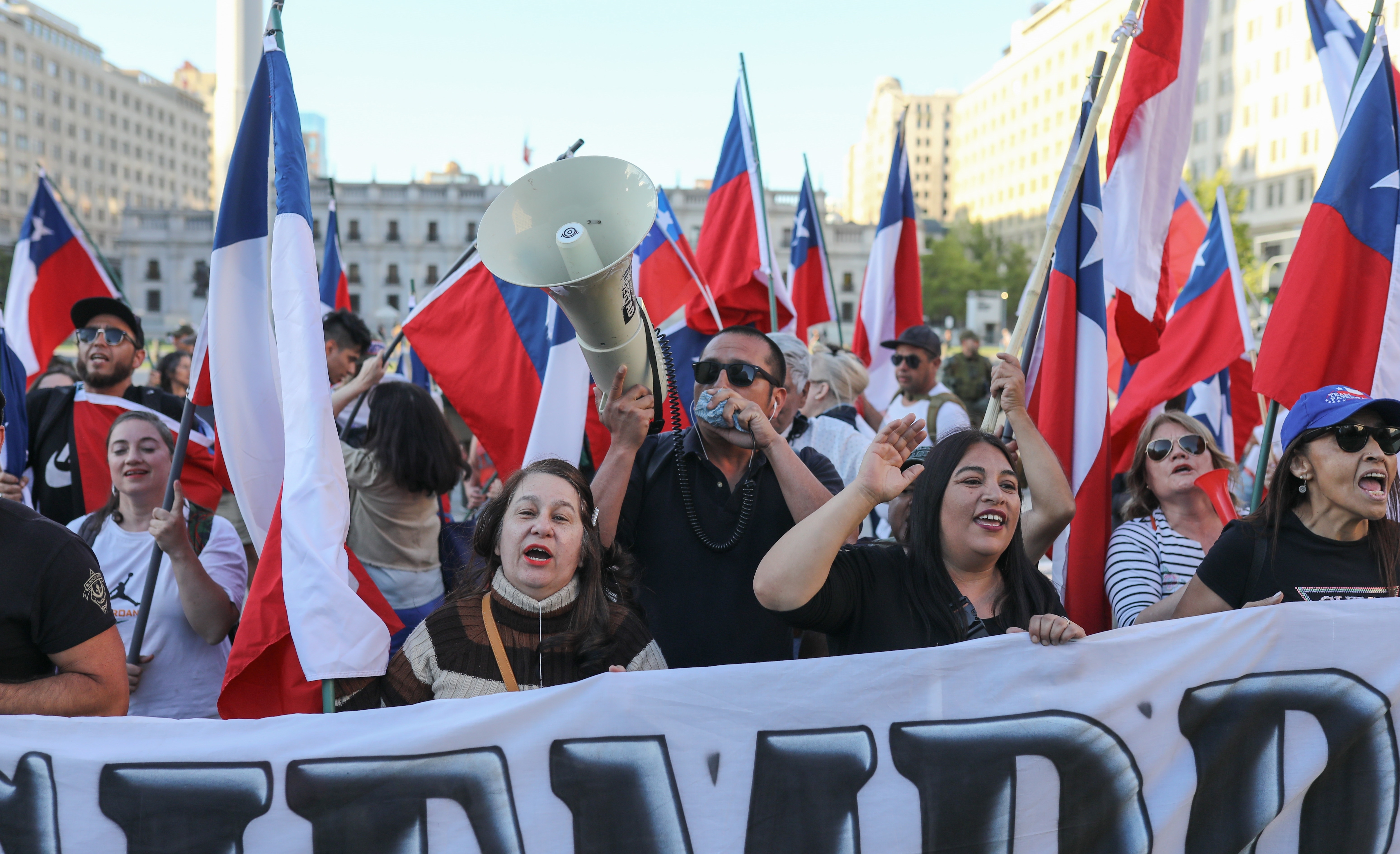 People celebrate in front of La Moneda Palace after the referendum on the proposal for a new constitution was rejected, in Santiago, Chile