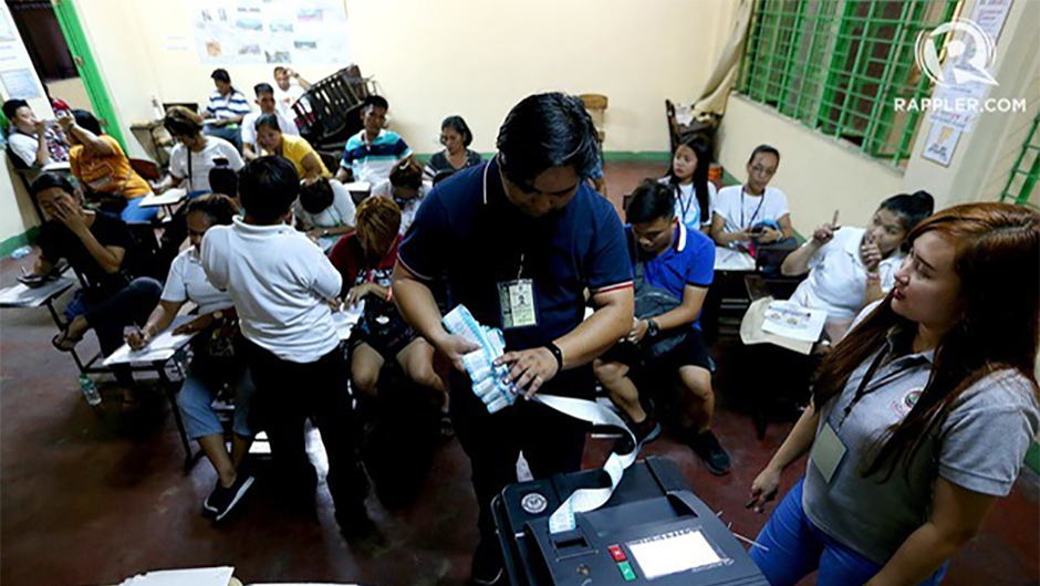 Voters PrecinctPoll watchers prepare the audit log from the vote-counting machines in Araullo High School, Manila, on May 13, 2019