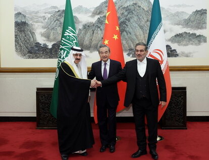 Wang Yi, China’s top diplomat (center), in Beijing on March 10, 2023, with counterparts Musaad bin Mohammed Al Aiban of Saudi Arabia and Ali Shamkhani of Iran