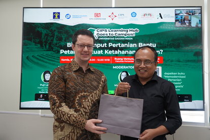 Dr. Stefan Diederich (Head of Office, FNF Indonesia) standing next to Professor Subejo (one of the speakers as well as our host from Universitas Gadjah Mada). Professor Subejo is holding a memento to be given to FNF and CIPS.
