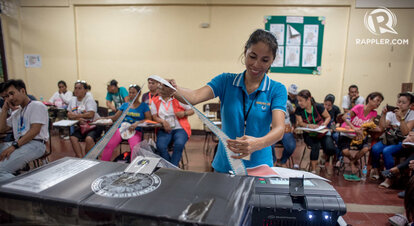 Board of Election canvassers print election returns as the poll closes in Araullo High School, Manila.