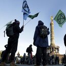 Supporters of the 'Extinction Rebellion' movement block a road at the Victory Column in Berlin, Germany, Monday, Oct. 7, 2019. The activists want to draw attention on the climate protest by blocking roads and with other acts of civil disobedience in Berlin and other cities around the world. 