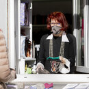 Diese Textilkünstlerin bleibt optimistisch und verkauft aus dem Fenster ihres Geschäfts in Berlin-Schöneberg Schutzmasken.
