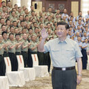 Xi Jinping in military attire greeting soldiers