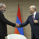 Russian President Vladimir Putin, right, and Armenian Prime Minister Nikol Pashinyan shakes hands during their meeting in the resort city of Sochi, Russia