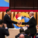 Chinese President Xi Jinping, left, and Russian President Vladimir Putin shake hands during the Belt and Road Forum at the Great Hall of the People in Beijing
