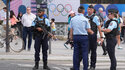 Before the Summer Olympics in Paris: Police officers stand guard in a street in Paris. 