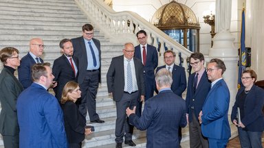 Members of the delegation speak with State Senator David Argall in the Pennsylvania State Capitol