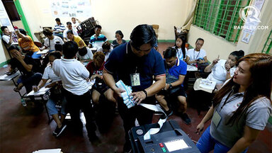 Voters PrecinctPoll watchers prepare the audit log from the vote-counting machines in Araullo High School, Manila, on May 13, 2019