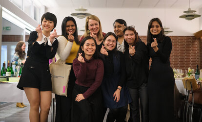 Kasturi (third person standing from the right) with friends she met in Gummersbach. All of them show poses of Korean finger hearts.